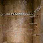 Luxurious tiled shower with multiple shower heads.
